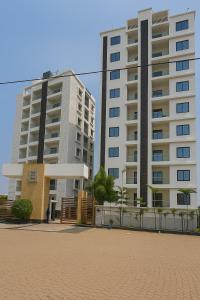two tall apartment buildings in a city with a courtyard at 2 Bhk Mayra Homes in Raipur