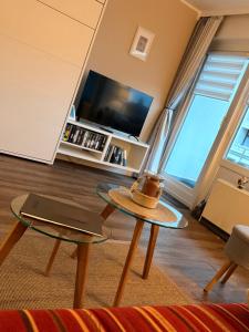 a living room with a table and a tv at Haus Westerhörn in Westerland