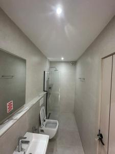 a bathroom with a toilet and a sink and a shower at Studio au point E in Dakar +12 photos