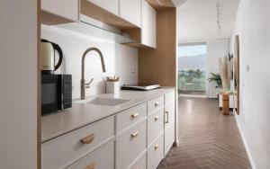 a kitchen with a sink and a microwave at סי סייד - אביה סונסטה in Eilat
