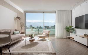 a living room with a couch and a table at סי סייד - אביה סונסטה in Eilat