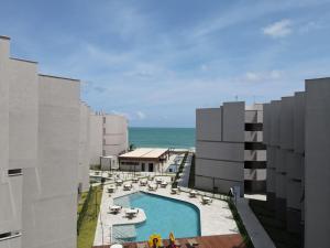 an aerial view of a resort with a swimming pool and the ocean at Nomar Carneiros - Flat Beira-mar in Tamandaré