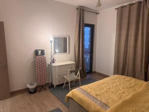 een slaapkamer met een bed, een bureau en een stoel bij Full apartment at excellent Community in Sharjah +10 foto's