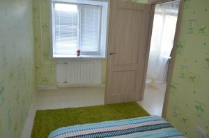 ノヴォシビルスクにあるApartments on Dusi Kovalchuk 266/1のベッドと窓が備わる小さな客室です。
