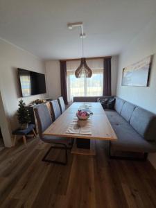 a living room with a table and a couch at Ferienhaus DaPfusterer in Bad Mitterndorf
