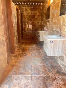a bathroom with a sink and a tile floor at Wadi Rum Bedoun in Wadi Rum