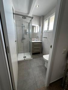 a bathroom with a shower and a toilet and a sink at Paradis Costa in La Pineda +19 photos
