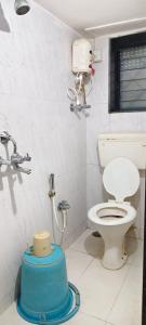 a bathroom with a toilet and a sink at Omkar Bungalow in Alibaug