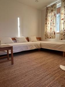 a bedroom with two beds and a window at 4borovice in Velká Lečice
