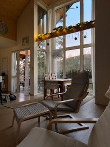 a living room with chairs and a table and windows at 4borovice in Velká Lečice +3 photos