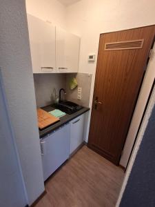 a small kitchen with a sink and a stove at Ferienwohnung Natalia in Thalfang
