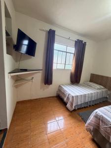 En eller flere senge i et værelse på Hotel Colombo