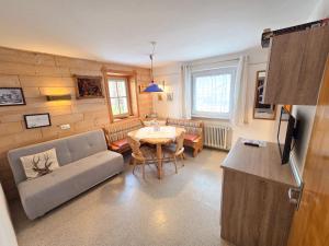 a living room with a couch and a table at am Mühlbach - Ferienwohnungen Luttinger in Bichlbach