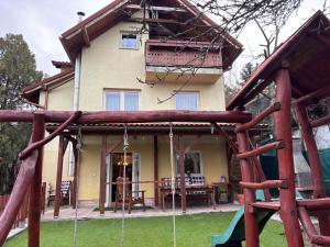 a house with a playground in front of it at Oliver's House in Budaörs