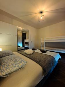 a bedroom with a large bed and a mirror at Apartman Fratelli in Ljubuški