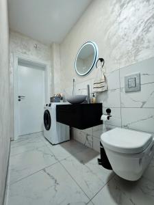 a bathroom with a toilet and a sink and a mirror at Apartman Fratelli in Ljubuški +35 photos