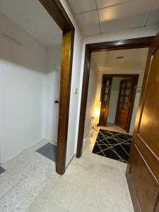 an empty hallway with a door and a room at Downtown Private room in Abu Dhabi