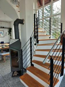 a staircase with a wood stove in a house at Ferienhaus Ellmi in Kronach