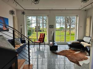 a living room with a couch and a chair at Ferienhaus Ellmi in Kronach
