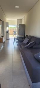 a living room with a couch and a table at Montebelle casa2 in Porangaba