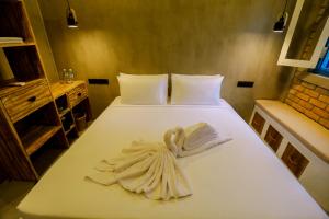 a white bed with towels on it in a room at Arcadian Weligama in Weligama