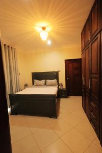 ein Schlafzimmer mit einem Bett mit einer Decke in der Unterkunft Homes by her in Entebbe