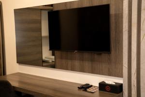 a television on a wall in a hotel room at Wan Hotel in Duhok