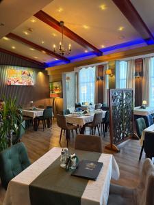 a restaurant with tables and chairs in a room at Hotel Previla in Sarajevo