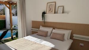 a bedroom with a bed with white sheets and pillows at Palmview Private Pool in Arguineguín +22 photos