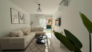 a living room with a couch and a table at Palmview Private Pool in Arguineguín