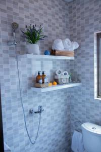 une salle de bain carrelée bleue avec douche et toilettes dans l'établissement Alojamento Local - Amor e Mar, à Luanda