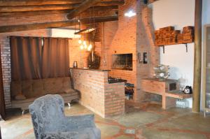 a living room with a brick fireplace and a couch at Casa de huéspedes Aruska in São Gabriel