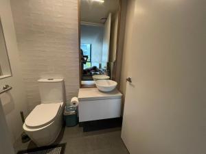 a bathroom with a white toilet and a sink at Boxhill home in Box Hill +39 photos