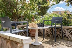 two chairs and a table with a chessboard on top at Es Marroig Villa y Spa in Llucmajor +35 photos