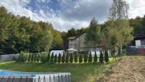 a yard with a fence and a house and a pool at Little Farm Nani in Visoko