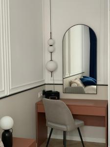 a bedroom with a desk with a chair and a mirror at Moon Deer in Jelenia Góra