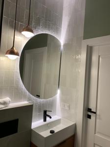 a bathroom with a sink and a mirror at Moon Deer in Jelenia Góra