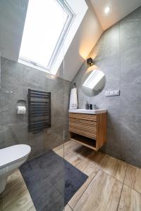 a bathroom with a sink and a skylight at Domek nad Potokiem 2 in Nowy Targ +174 photos