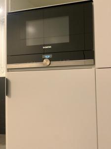 a flat screen tv on top of a refrigerator at Moon Deer in Jelenia Góra