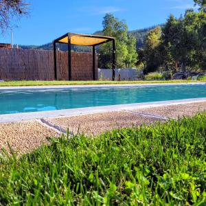 una piscina con un canestro da basket nell'erba di Achibueno Glamping a Linares