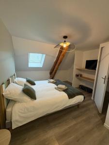 a bedroom with a large white bed in a room at Escapade à Pierry in La Celle-sous-Gouzon