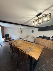 a dining room with a table and a couch at Escapade à Pierry in La Celle-sous-Gouzon +18 photos