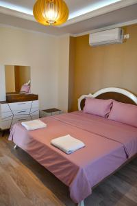 En eller flere senge i et værelse på The White Villa