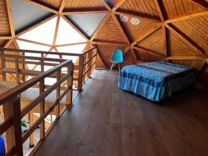 een kamer met een bed in een houten kamer bij Domo Algarrobo 2 in Algarrobo