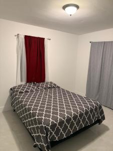 a bedroom with a black and white comforter on a bed at 2 bedroom 2467 in Miami