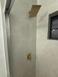 a shower with a door with a shower head at 2 bedroom 2467 in Miami