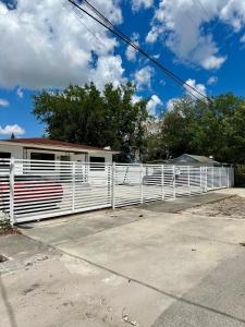 a white fence in front of a house at 2 bedroom 2467 in Miami