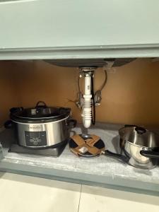a kitchen counter with two pots and pans under a sink at 2 bedroom 2467 in Miami +6 photos