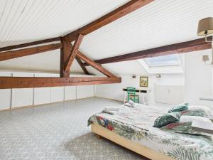 a bedroom with a bed and a vaulted ceiling at Séjourner au Château de la Roue Grand appartement in Lissieu