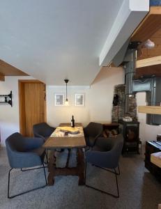a living room with a wooden table and chairs at Rustico Guidotti in Bellinzona
